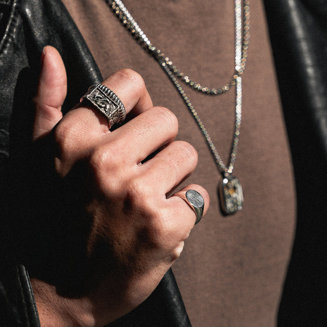 silver dragon ring on a finger