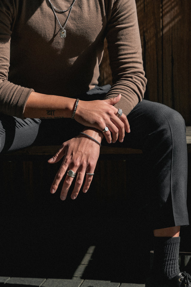 Silver bracelets on wrists