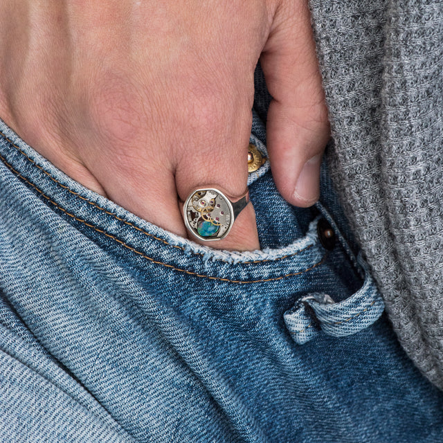 round vintage ring with australian opal on a finger