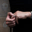 silver band ring on a finger