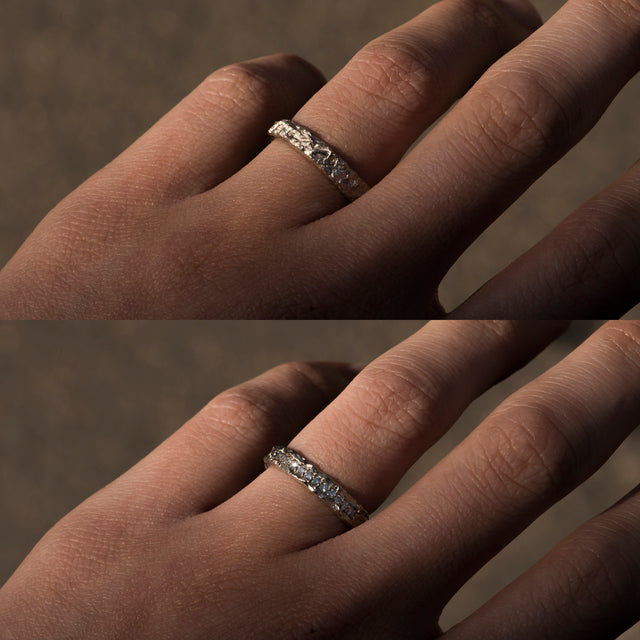 white moissanite silver ring on a finger